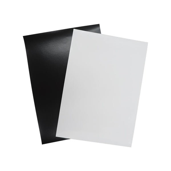 Two overlapping sheets of paper, one black and one white, on a plain background.